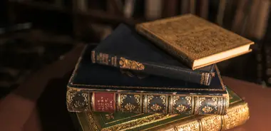A brown hardbound book on a wooden table