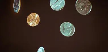 Silver coins lying on a white surface
