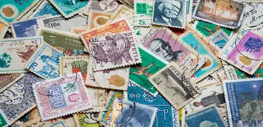 Assorted postage stamps on blue and white fabric