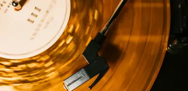 A translucent amber vinyl record spinning on a turntable