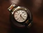 Steel and gold wristwatch with a white dial